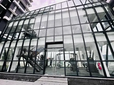a large glass building with an open door at Skycity & Sea View Penang 3BR 10Pax in George Town