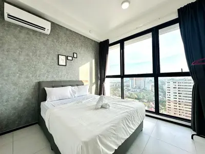 a bedroom with a white bed with a large window at Skycity & Sea View Penang 3BR 10Pax in George Town