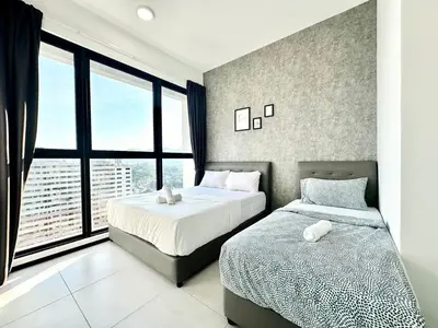 a bedroom with two beds and a large window at Skycity & Sea View Penang 3BR 10Pax in George Town