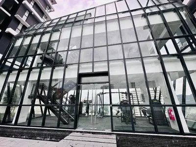 a large glass building with an open door at Sea View Condo In Georgetown 10 pax in George Town