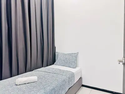 a small bedroom with a bed and a curtain at Sea View Condo In Georgetown 10 pax in George Town