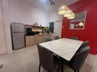 a kitchen with a table and chairs in a room at RedHouse Sky Garden Klabang 10 pax in Chemor