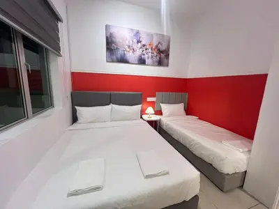 two beds in a room with red and white walls at RedHouse Sky Garden Klabang 10 pax in Chemor