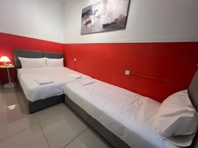 two beds in a small room with red walls at RedHouse Sky Garden Klabang 10 pax in Chemor
