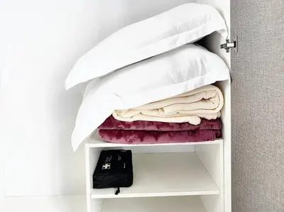 a closet with a bed and towels on a shelf at TheFloral Penthouse Night Market Wifi & Netflix in Brinchang