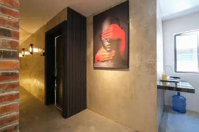 a hallway with a painting of a face on the wall at Loft 82 in Bukit Mertajam