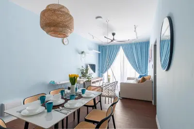 a dining room and living room with a table and chairs at Royo Homestay in Palas Horizon in Brinchang