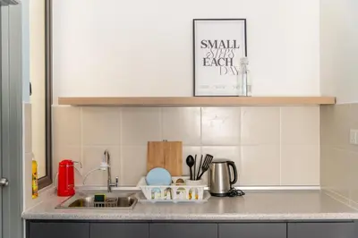 a kitchen counter top with a sink and a counter top at Royo Homestay in Palas Horizon in Brinchang