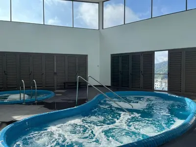 a jacuzzi tub with water in a building at Royo Homestay in Palas Horizon in Brinchang