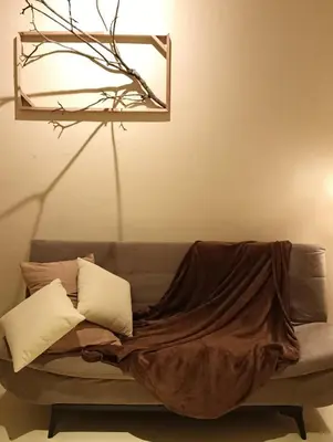 a couch with a blanket on it in a living room at Senju Georgetown Heritage PrewarHouse 4BR 5-15 pax in George Town