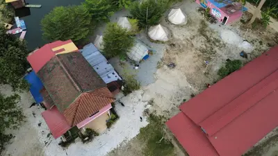 an overhead view of a group of buildings next to the water at Tok Mat Village & Adventure Park in Kampong Kepayang