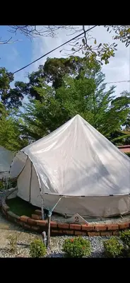 a large white tent sitting in a yard at Tok Mat Village & Adventure Park in Kampong Kepayang