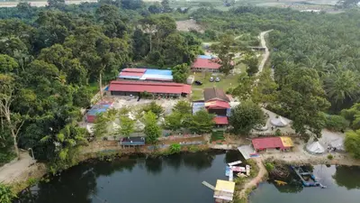 an aerial view of a resort next to a body of water at Tok Mat Village & Adventure Park in Kampong Kepayang