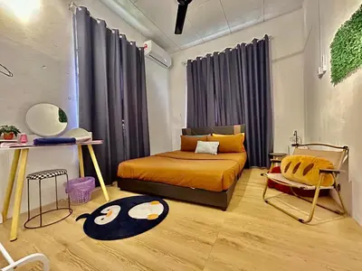 a bedroom with a bed and a chair in it at Cozy95#6pax#Netflix#SukunBukitMertajam in Bukit Mertajam