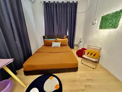 a bedroom with a large bed and a chair at Cozy95#6pax#Netflix#SukunBukitMertajam in Bukit Mertajam