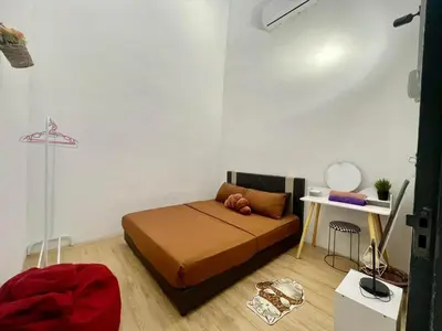 a small bedroom with a bed and a table at Cozy95#6pax#Netflix#SukunBukitMertajam in Bukit Mertajam