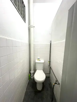 a bathroom with a white toilet in a stall at Cozy95#6pax#Netflix#SukunBukitMertajam in Bukit Mertajam