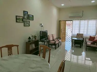 a living room with a table and chairs at Aloe Vera Homestay - 3 Bed Rooms Corner House in Kamunting