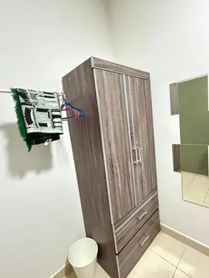 a wooden cabinet in a bathroom with a toilet at AYAAN CLUB HOUSE Free WiFI & Netflix in Cameron Highlands