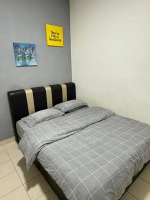 a bed in a room with a sign on the wall at AYAAN CLUB HOUSE Free WiFI & Netflix in Cameron Highlands
