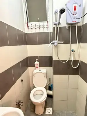 a small bathroom with a toilet and a shower at AYAAN CLUB HOUSE Free WiFI & Netflix in Cameron Highlands