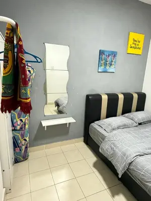 a bedroom with a bed and a mirror at AYAAN CLUB HOUSE Free WiFI & Netflix in Cameron Highlands