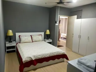 a bedroom with a bed with two night stands and two lamps at Champs elysees in Kampar