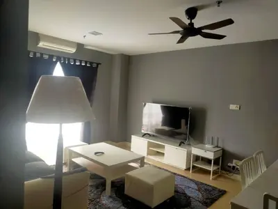 a living room with a television and a ceiling fan at Champs elysees in Kampar