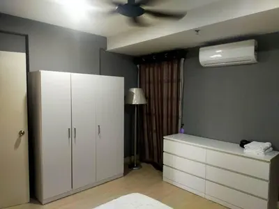 a bedroom with a white cabinet and a ceiling fan at Champs elysees in Kampar