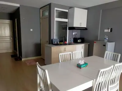 a kitchen with a white table and white chairs at Champs elysees in Kampar
