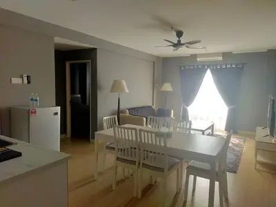 a kitchen and living room with a table and chairs at Champs elysees in Kampar