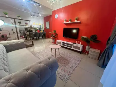 a living room with a couch and a tv at RedHouse Sky Garden Klabang in Ipoh