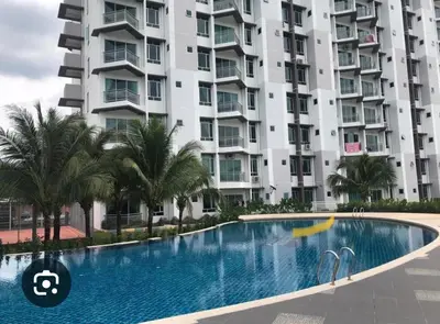 a swimming pool in front of a large building at RedHouse Sky Garden Klabang in Ipoh