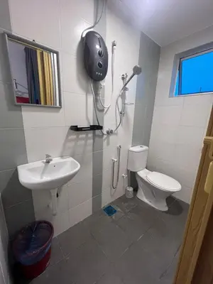 a bathroom with a toilet and a sink at RedHouse Sky Garden Klabang in Ipoh