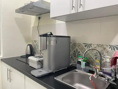 a kitchen counter with a mixer and a sink at The Anderson Ipoh Town in Ipoh