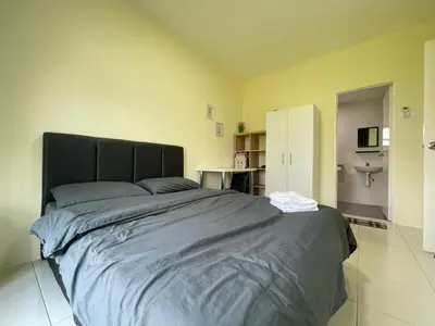 a bedroom with a large bed and a bathroom at The Anderson Ipoh Town in Ipoh