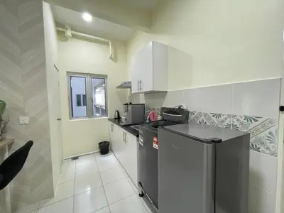 a kitchen with a refrigerator and a counter top at The Anderson Ipoh Town in Ipoh