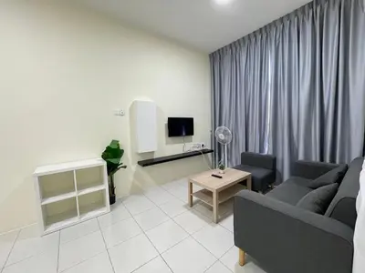 a living room with a couch and a tv at The Anderson Ipoh Town in Ipoh