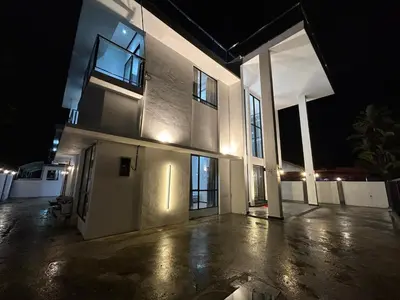 a large white house at night with lights at Khoo Family Villa in Ipoh