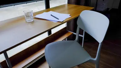 a wooden desk with a chair and a glass at Khoo Family Villa in Ipoh
