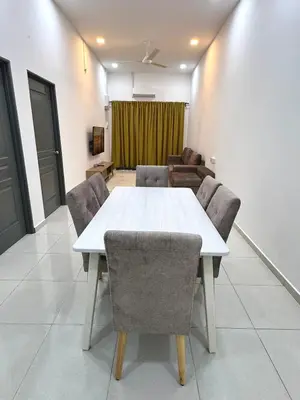 a conference room with a white table and chairs at Haneya Homestay in Kampong Banggol Pasir