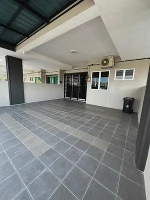 an empty room with a tile floor in a house at Haneya Homestay in Kampong Banggol Pasir