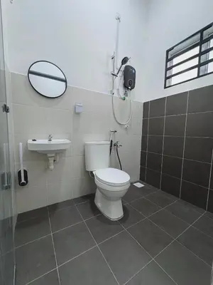 a bathroom with a toilet and a sink at Haneya Homestay in Kampong Banggol Pasir