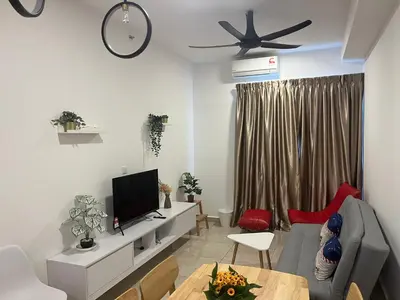 a living room with a couch and a tv at ICC Suites Ipoh Walking distance to Mall in Ipoh