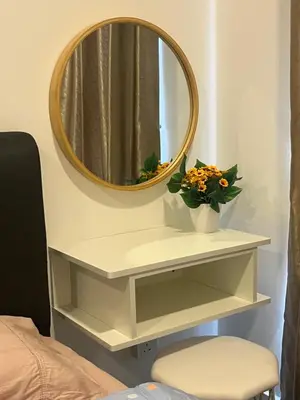 a mirror above a white shelf with a vase of flowers at ICC Suites Ipoh Walking distance to Mall in Ipoh