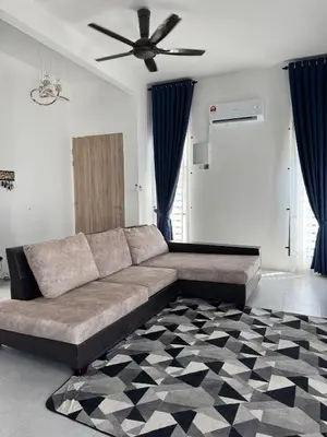 a couch in a living room with a ceiling fan at Lapang Tuju Private Pool Homestay in Sungai Petani