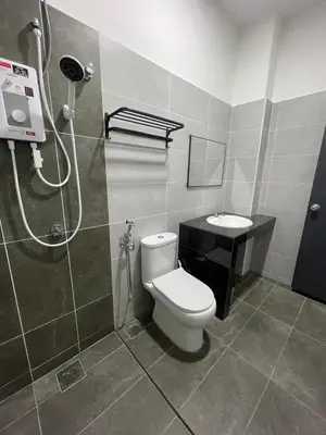 a bathroom with a shower and a toilet and a sink at Gaya's Homestay Sri Klebang in Ipoh