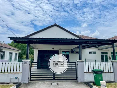 a house with a sign in front of it at Cozy Home Aman Selesa Netflix Wifi Usm in Parit Buntar