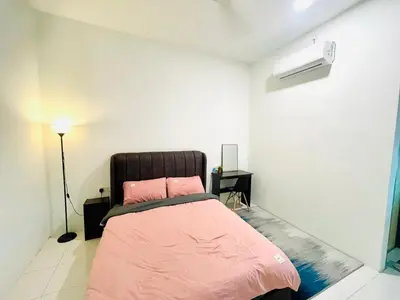a bedroom with a bed with pink sheets and a lamp at Cozy Home Aman Selesa Netflix Wifi Usm in Parit Buntar