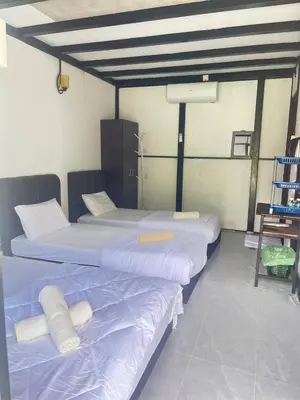 a couple of beds in a room at Belibis Yard in Kampar